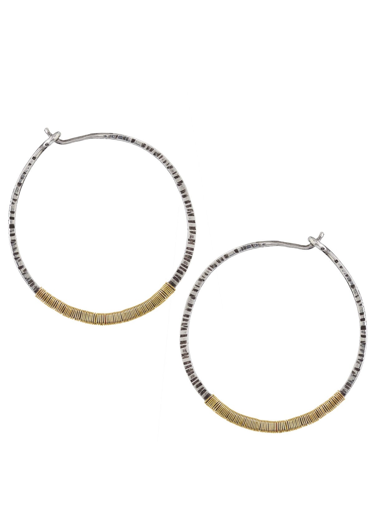 Hoop earrings in sterling silver and 14k gold fill with hand-textured finish and hand wire-wrapped detail.