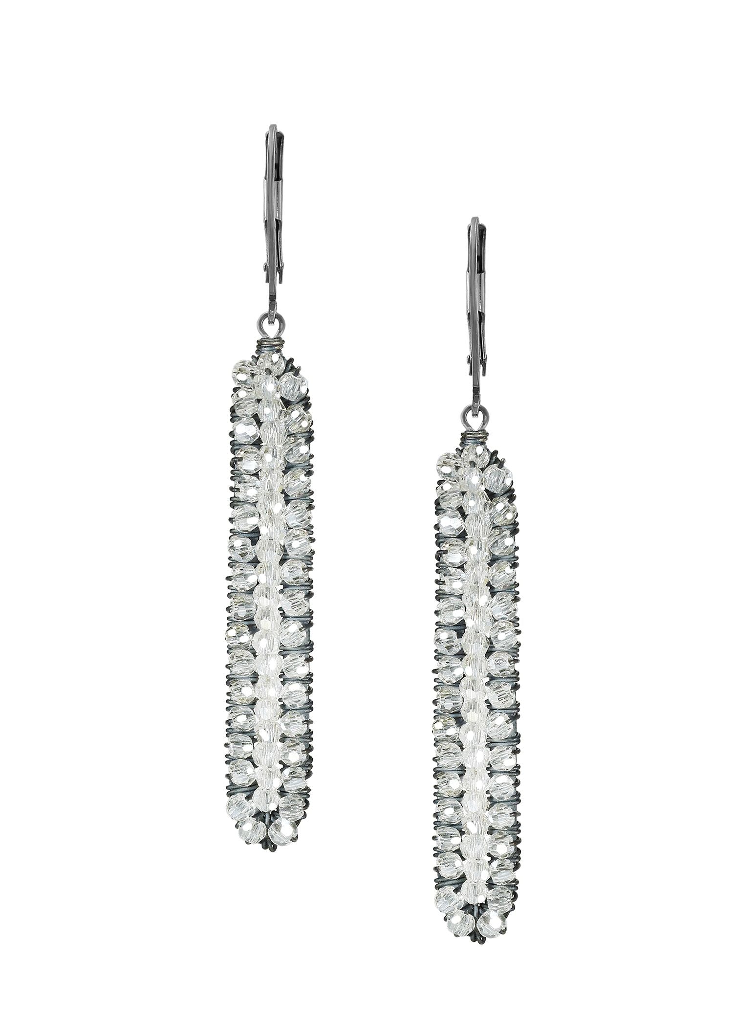 Crystal earrings in sterling silver with hand wire-wrapped clear beads in a long, slender rectangular icicle shape.