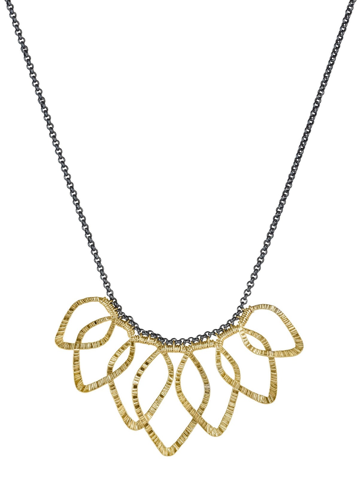 Leaf bib necklace featuring overlapping textured 14k gold fill leaves on an oxidized sterling silver chain.