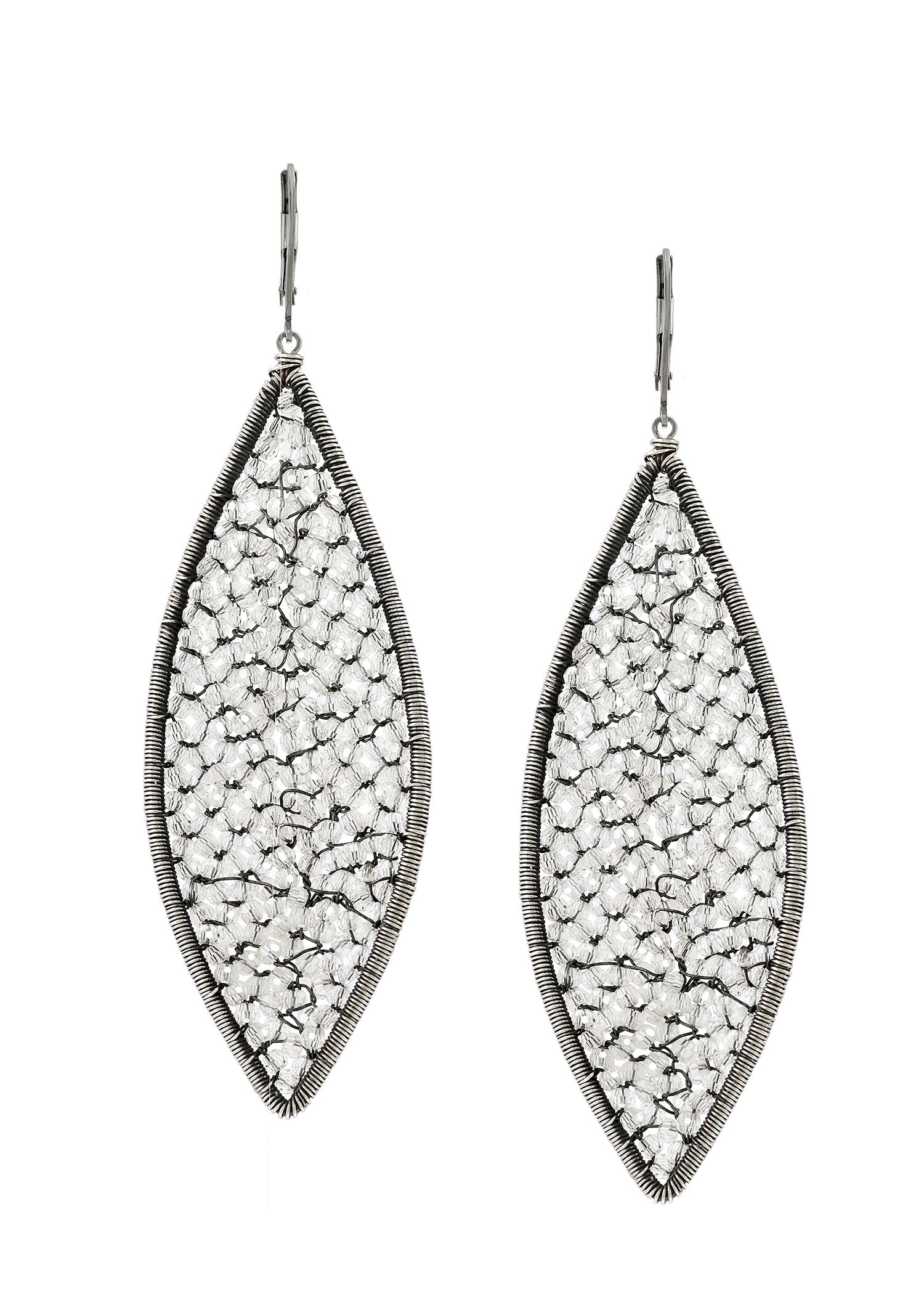 Crystal earrings in sterling silver, featuring hand wire-wrapped flame-shaped designs with clear crystals.