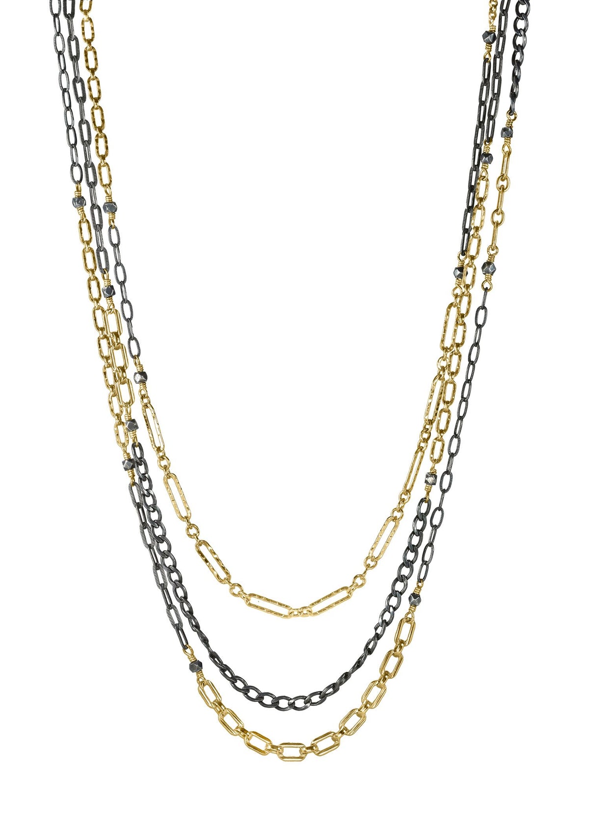 Triple strand necklace in 14k gold fill and blackened sterling silver with faceted silver beads on mixed metal chains.