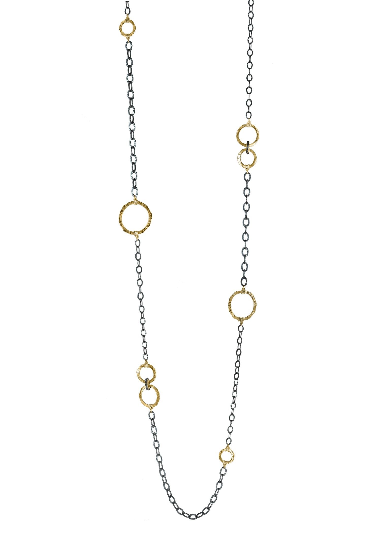 Sunburst necklace with 14k gold fill rings on a blackened sterling silver chain featuring hand-textured line patterns.